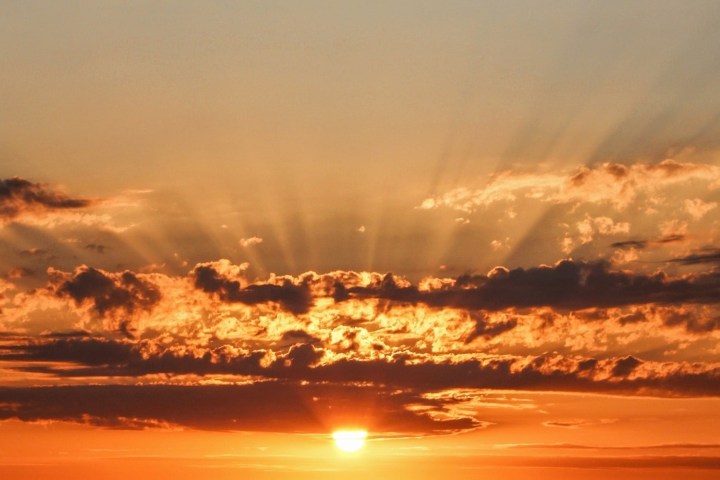 a group of clouds in the sky at sunset